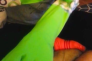 Wife jerks cock with green rubber...
