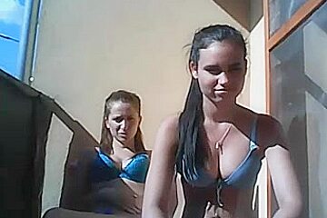 Two girls topless balcony...