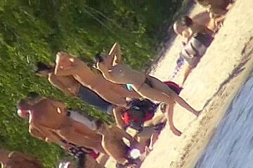 Cute brunette with black thong in the beach video