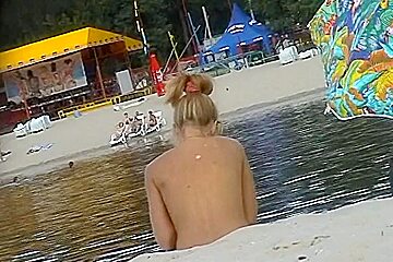 Hot blonde gets naked at the beach for nudists