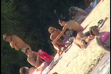 Adorable housewife smears her boobs on the beach