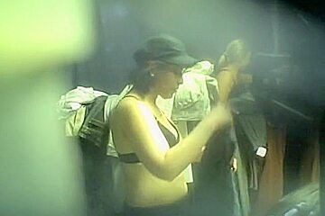 Spy cam chick in cap without the top in dressing room