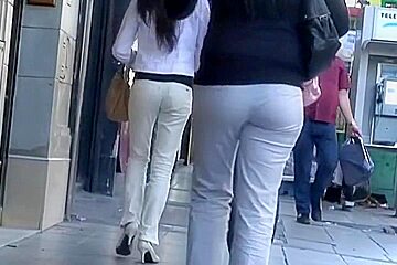 Woman pants walks street in front...