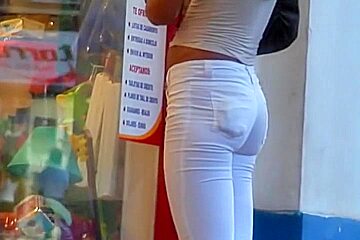 Sexy tanned babe in white jeans...