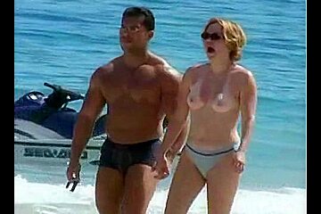 Naked couple enjoying themselves beach...