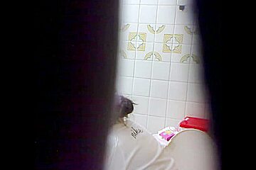 Peeing babe filmed from a far by a hidden camera
