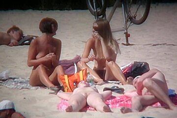 Stunning nude chicks relaxing beach here...