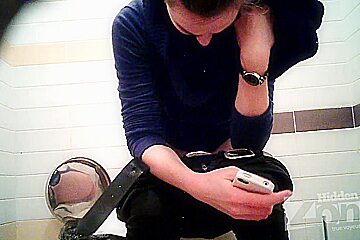Sexy girl caught on the hidden spy camera in the public toilet
